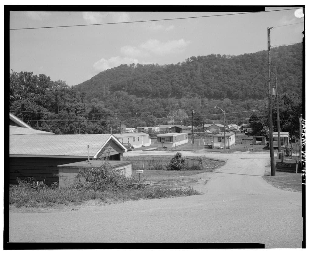 Historic view of homes, streets, and wooded hills in Chelyan, West Virginia